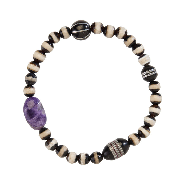 Tibetan Agate Beaded bracelet with a charoite stone on a white background