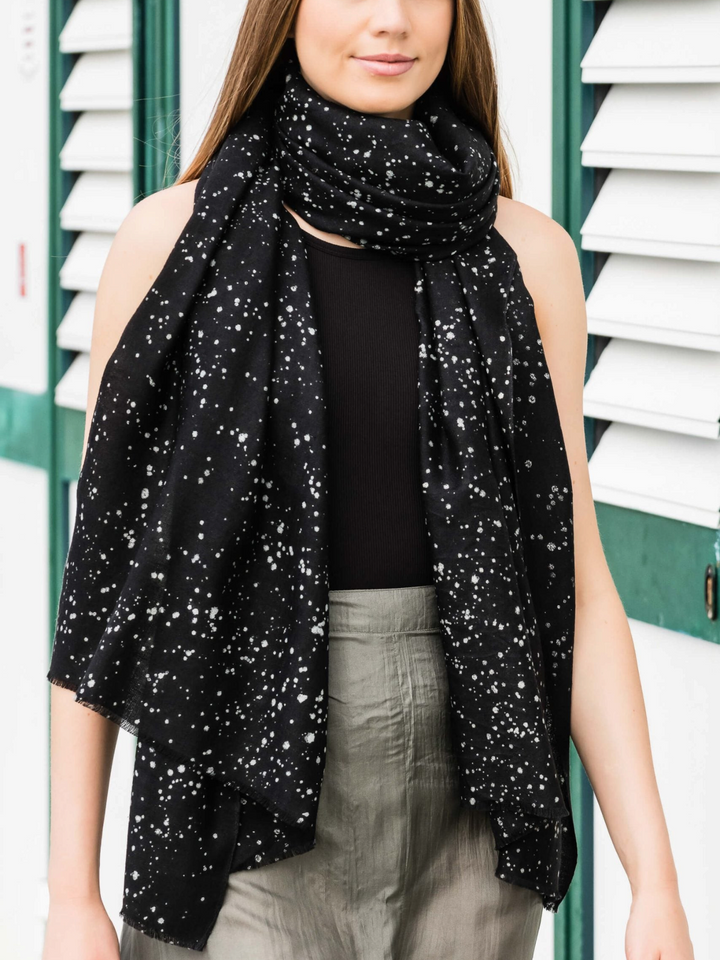 Ileana Makri Bergamotto 172 black cashmere scarf with subtle shimmer, draped elegantly over a model's shoulders.