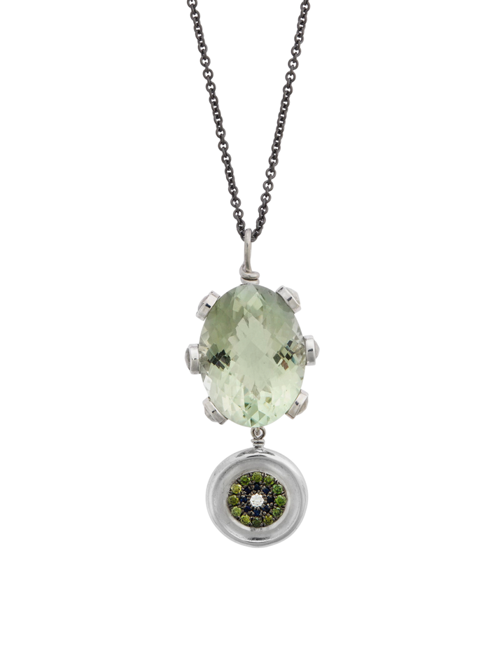 Ileana Makri double eye pendant featuring a green amethyst, green diamonds, and sapphires on a dark steel chain.