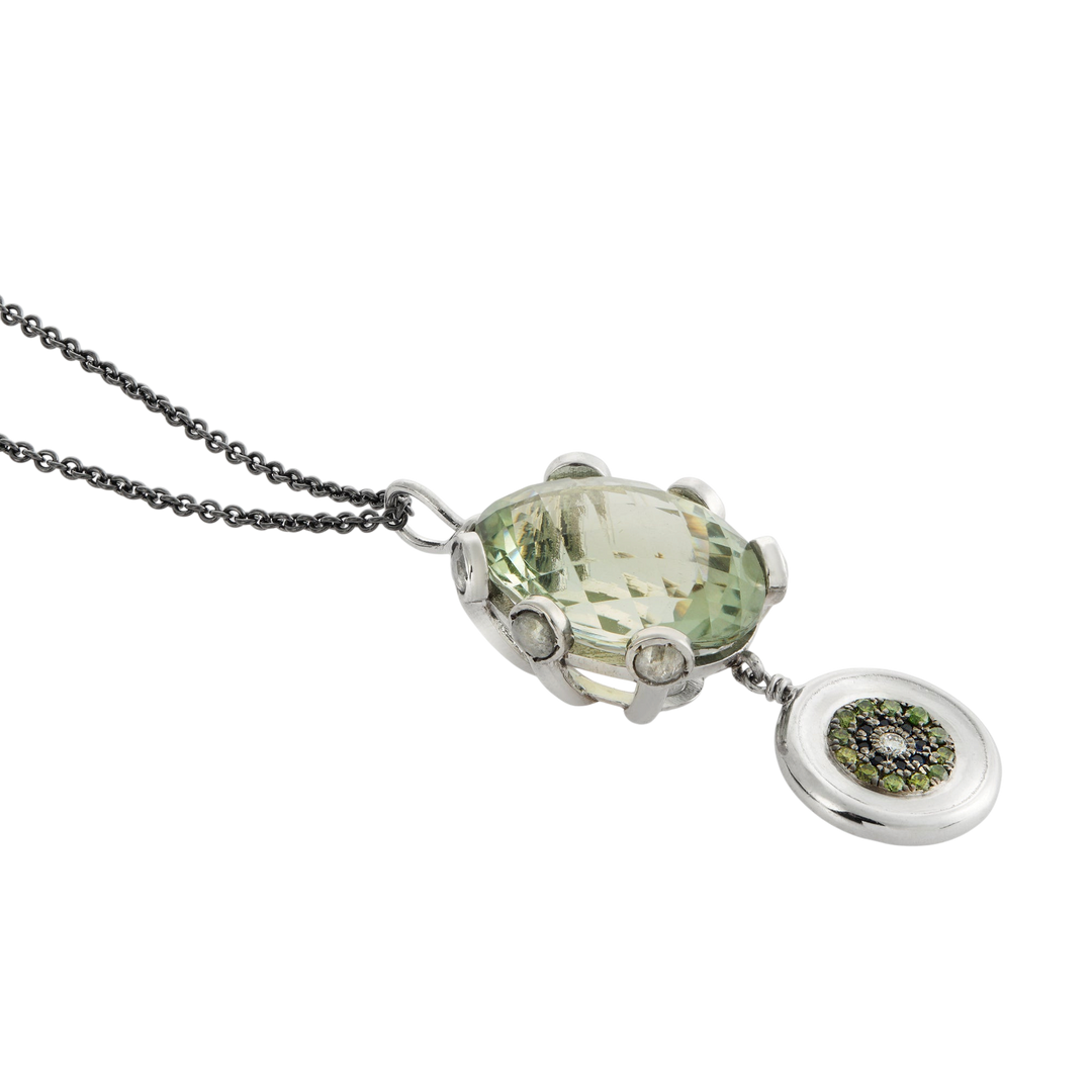 Ileana Makri double eye pendant featuring a faceted green amethyst, green diamonds, and sapphires on a steel chain.