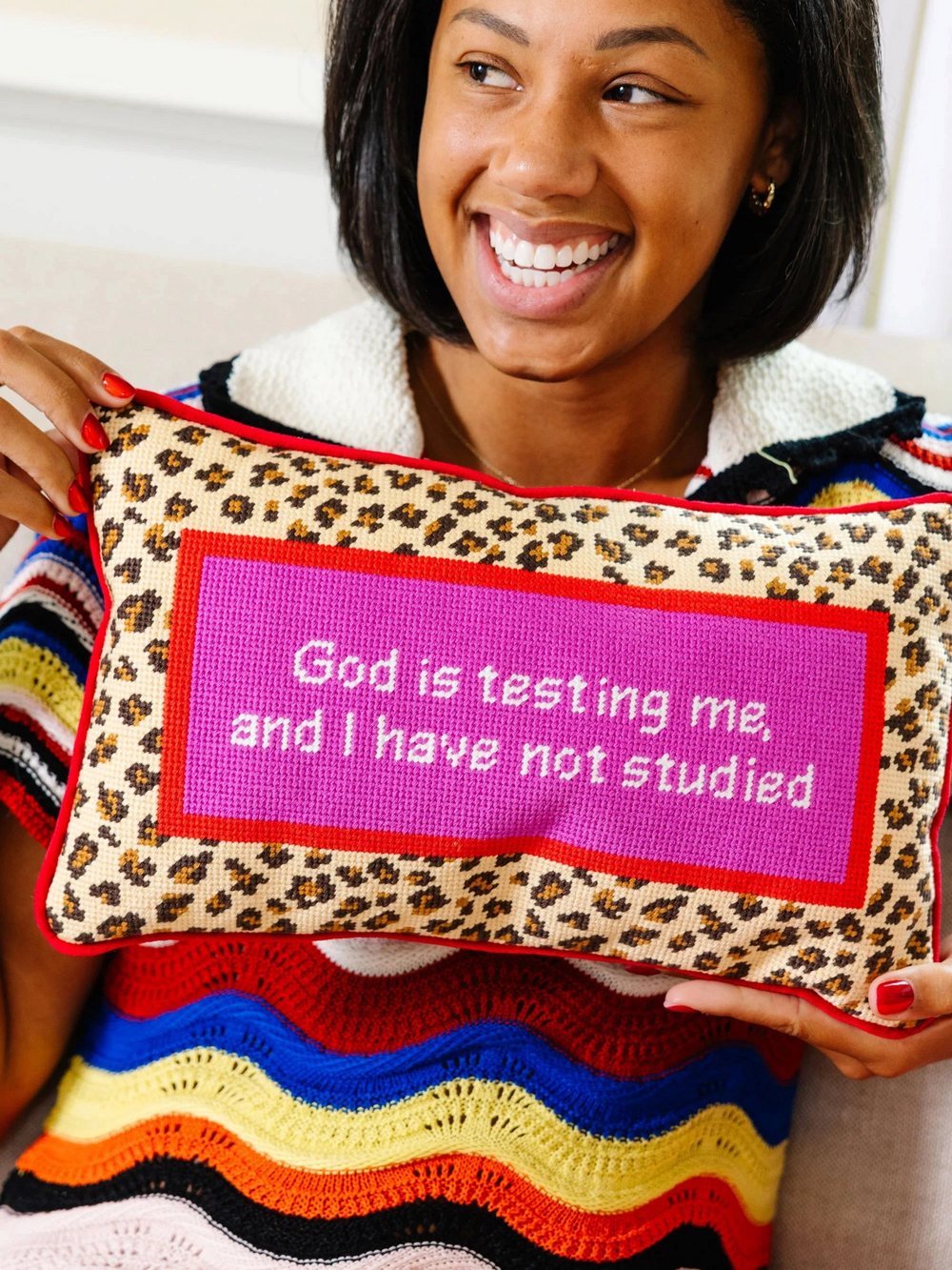 Ileana Makri needlepoint pillow with leopard print border and pink center featuring the text God is testing me