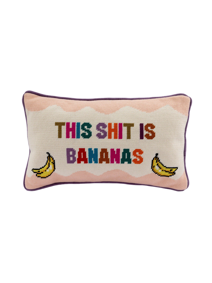 Ileana Makri needlepoint pillow with pink wavy background, banana illustrations, and colorful text on velvet backing.