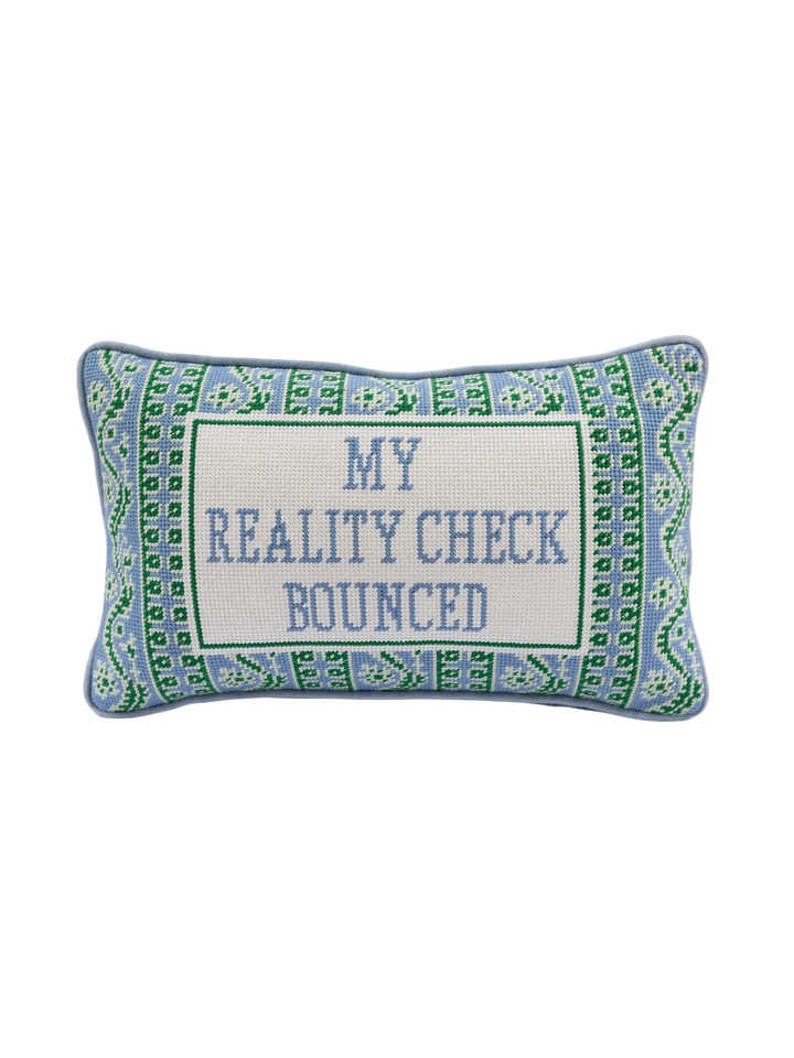 Ileana Makri Reality Check needlepoint pillow with blue and green geometric border and My Reality Check Bounced text.