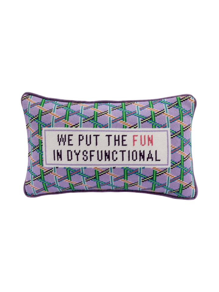 Ileana Makri needlepoint pillow featuring a purple plaid pattern and the embroidered phrase We Put The Fun In Dysfunctional