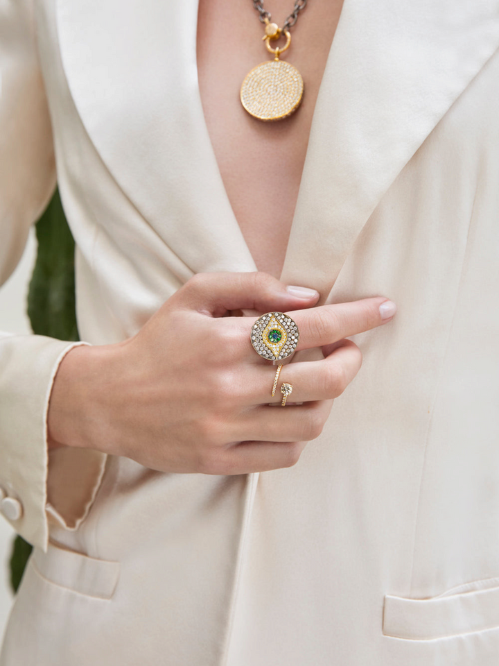Ileana Makri Dawn Candy ring in 18k yellow gold with emeralds, diamonds, and sapphire worn on a model in a blazer.