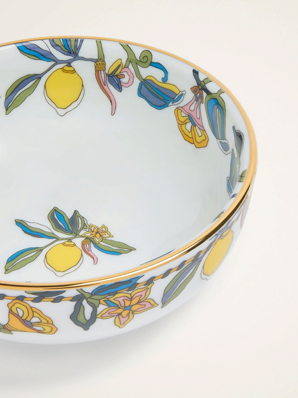 Ileana Makri Borboni ceramic snack bowl with white base, gold rim, and colourful lemon and floral motif pattern.