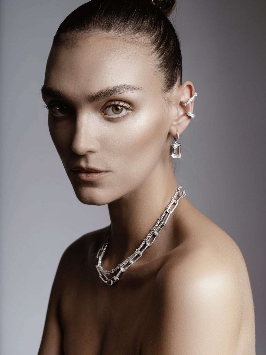 Ileana Makri Royal Crown white gold hoops with white topaz and diamond accents worn by a model with a matching necklace