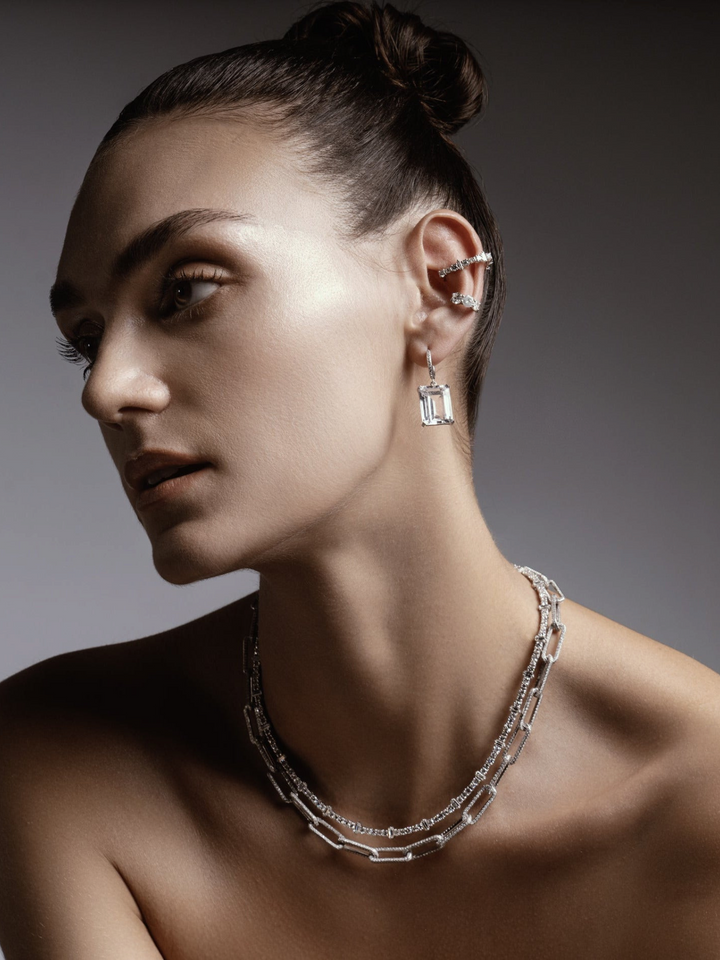 Ileana Makri Royal Crown white gold hoop earring with white topaz and diamond accents worn by a model