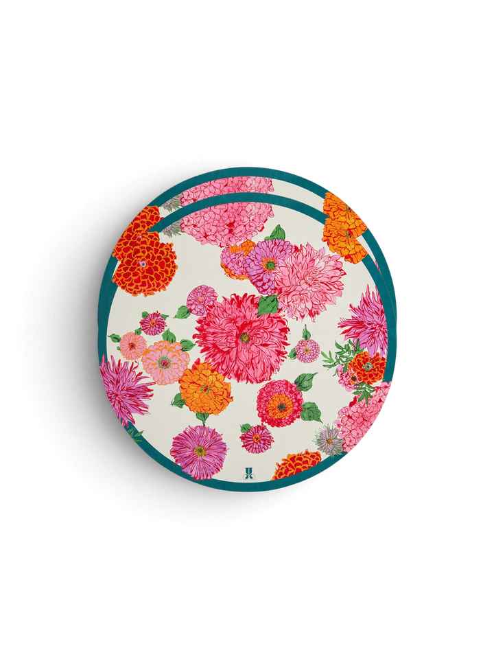 Ileana Makri Bright Blooms circular placemats featuring a vibrant pink and orange floral print with a teal border.