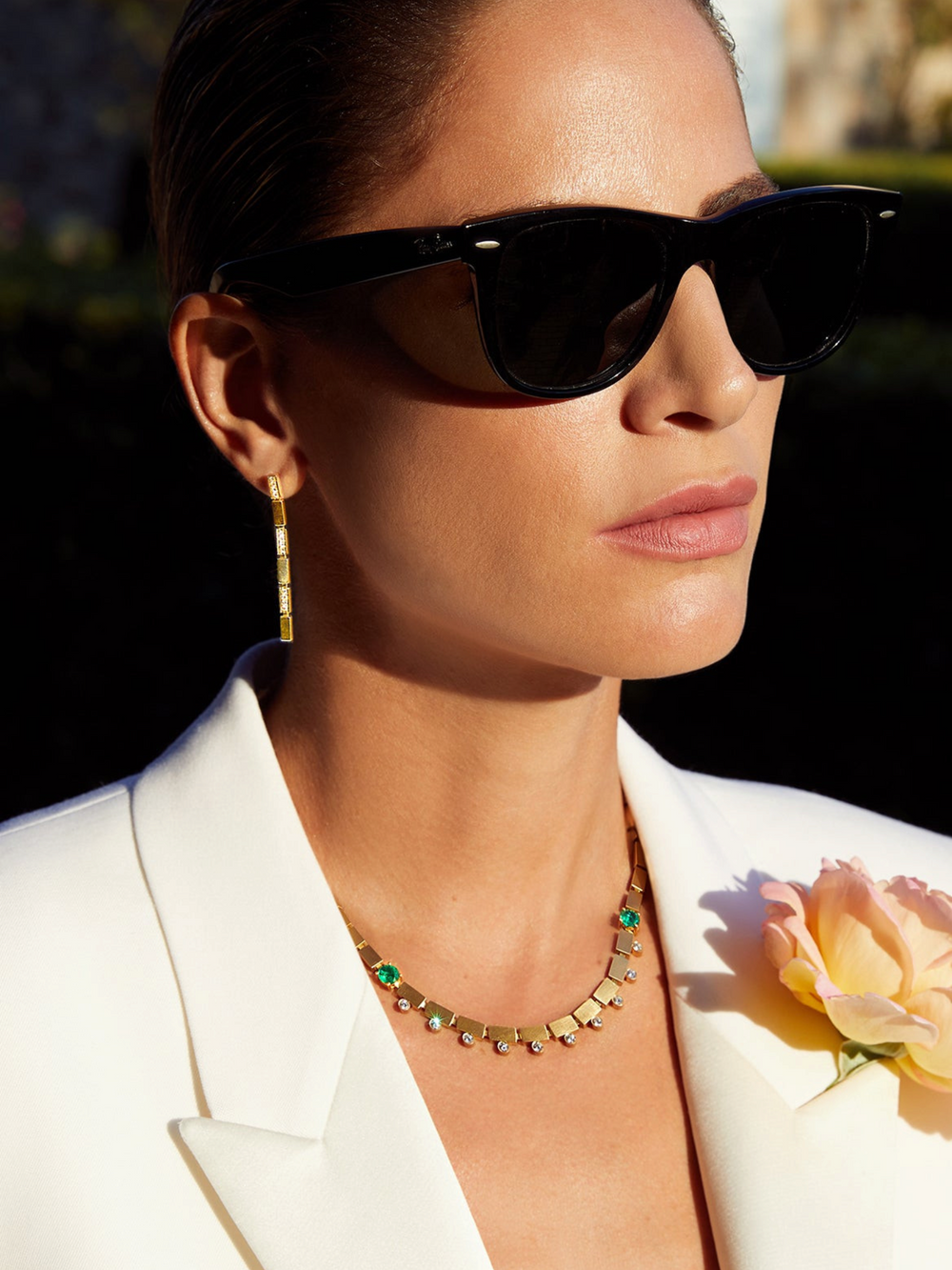 Ileana Makri single waterfall earring in 18k yellow gold with white diamonds worn by a woman in a white blazer.