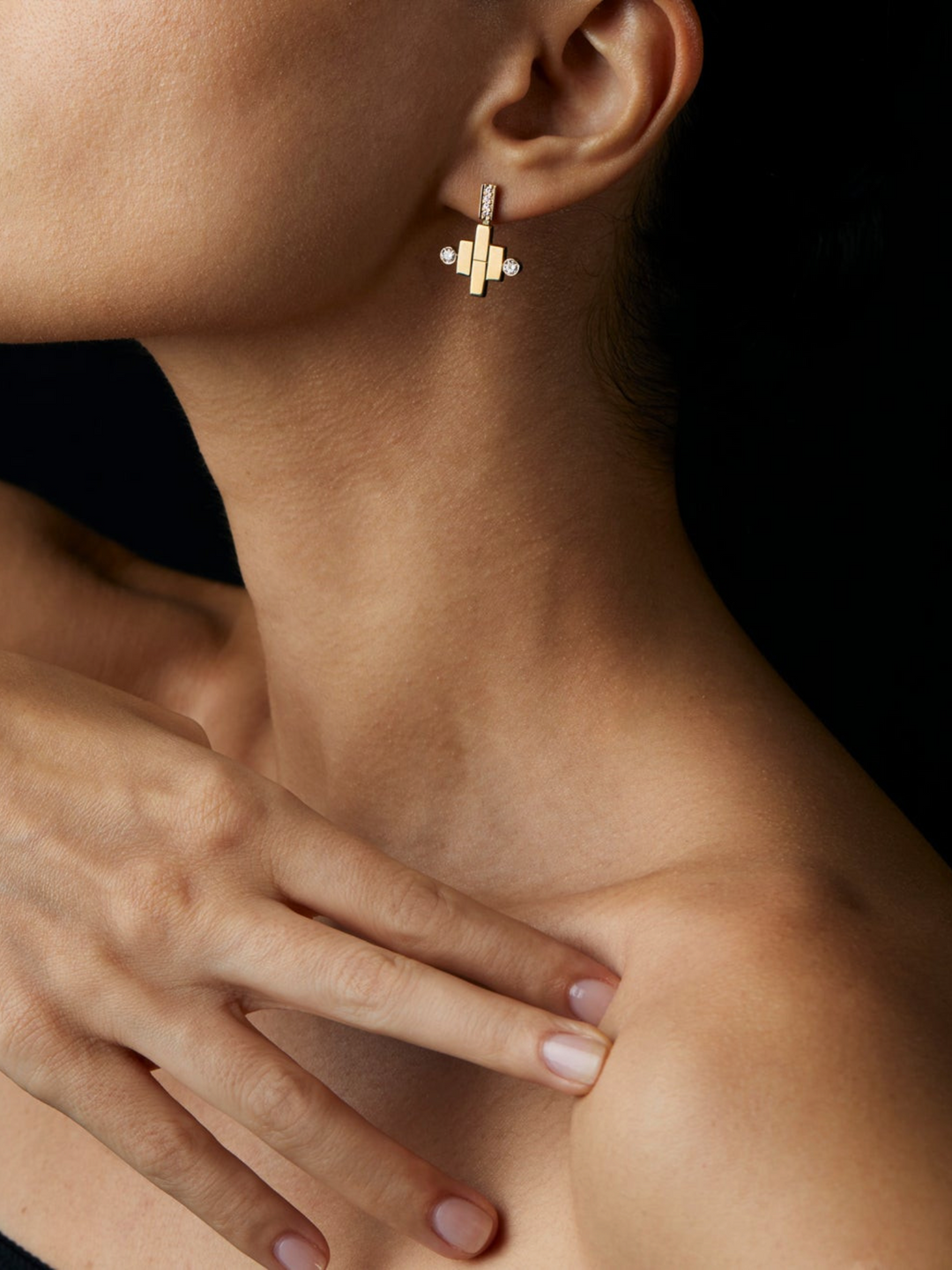 Ileana Makri dangling pond earrings in 18K yellow gold with pave white diamonds worn on a model