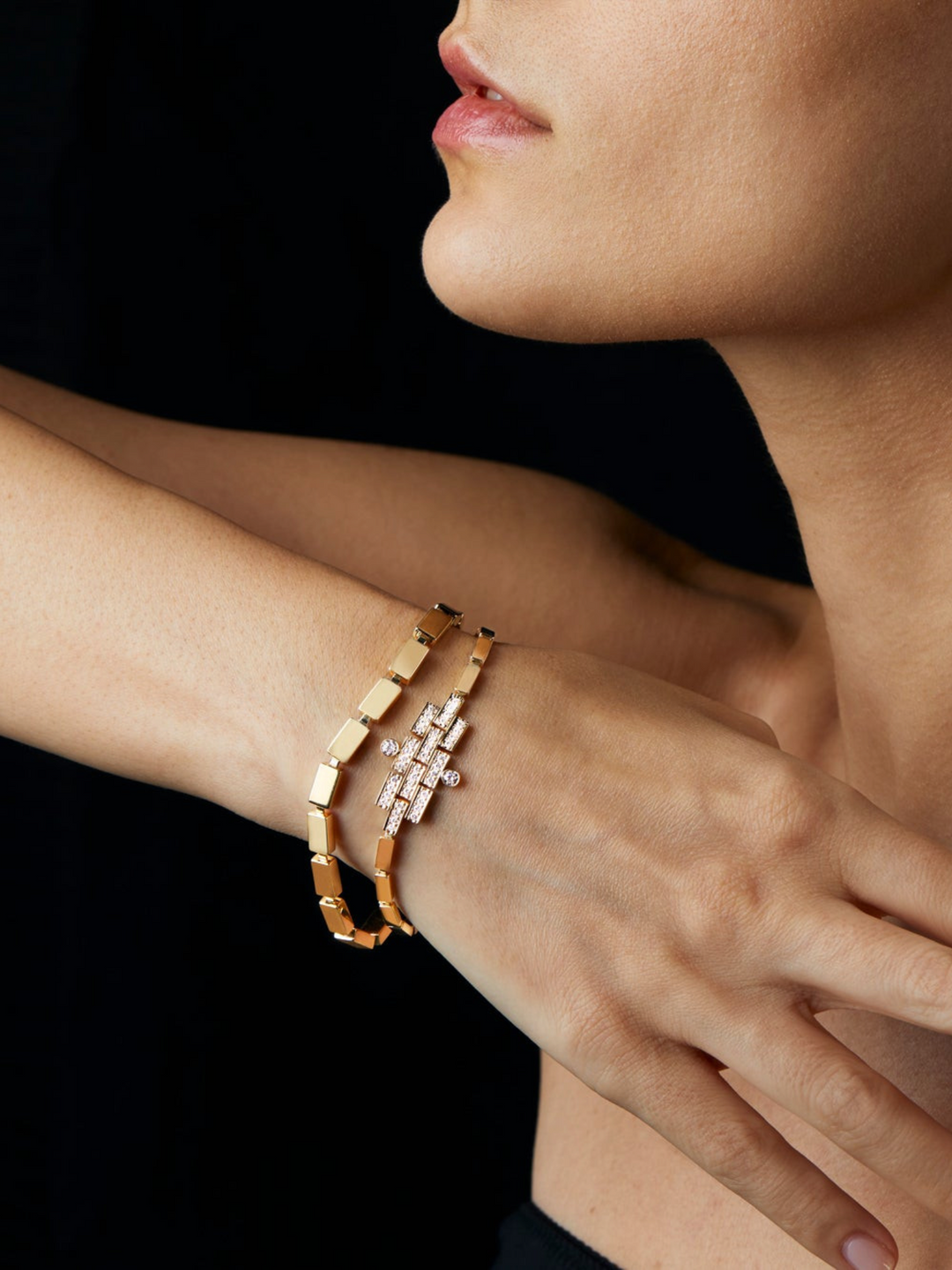 Ileana Makri triple waterfall bracelet in 18k yellow gold with white diamonds worn on a woman's wrist