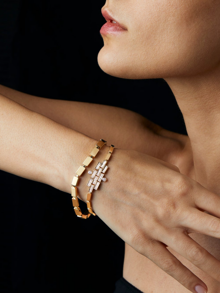 Ileana Makri triple waterfall bracelet in 18k yellow gold with white diamonds worn on a woman's wrist