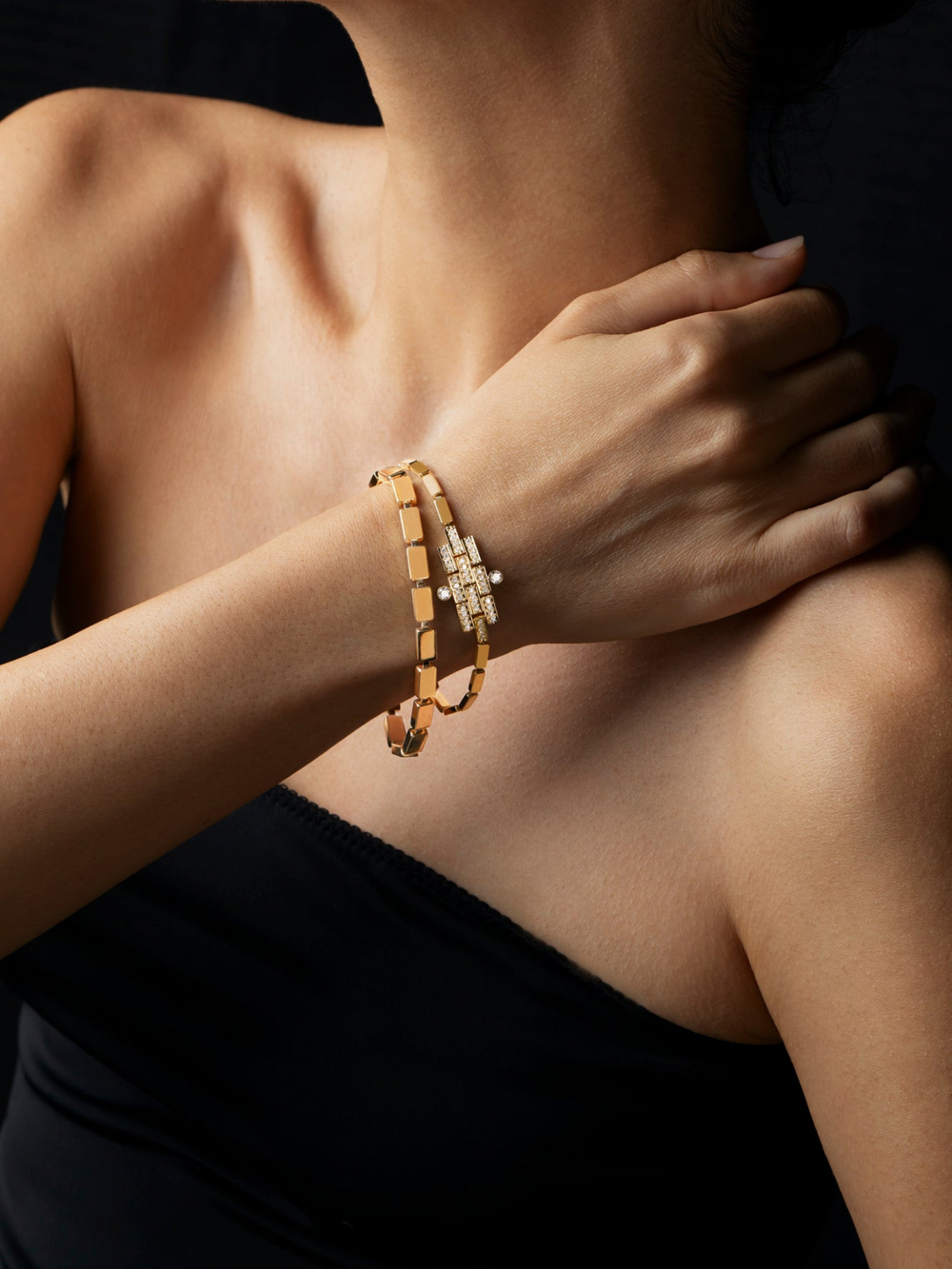 Ileana Makri 18k yellow gold waterfall bracelet with delicate linear links worn on a model against a black background