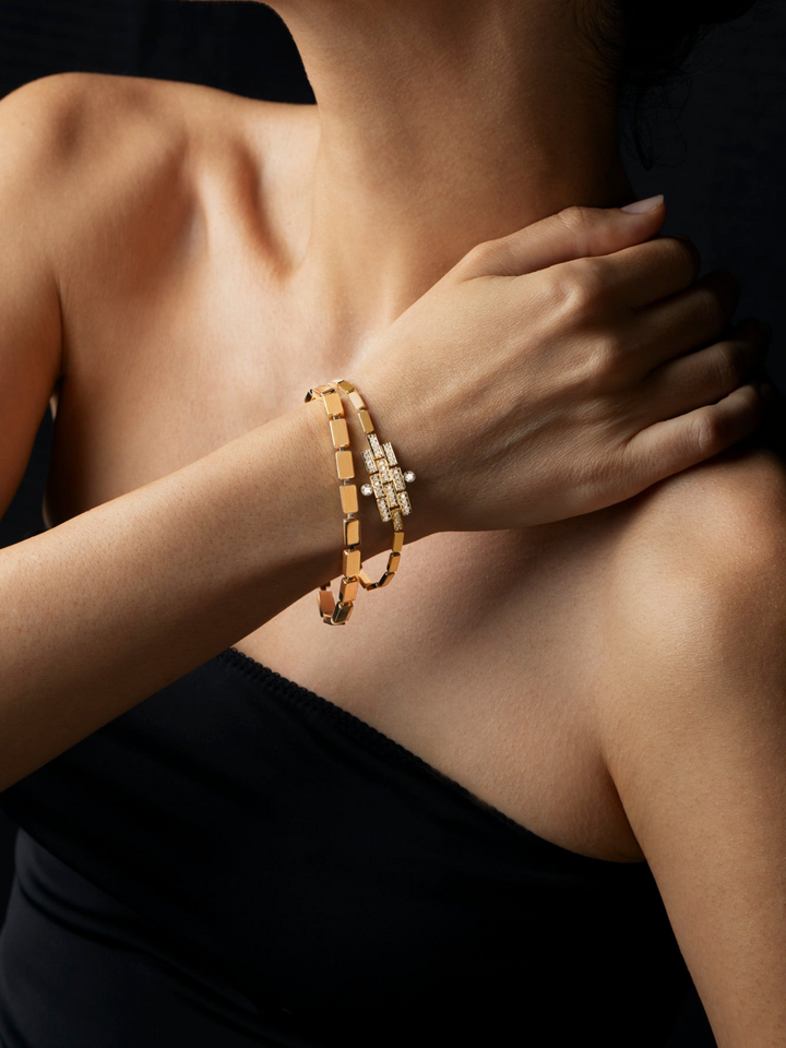 Ileana Makri 18k yellow gold waterfall bracelet with delicate linear links worn on a model against a black background