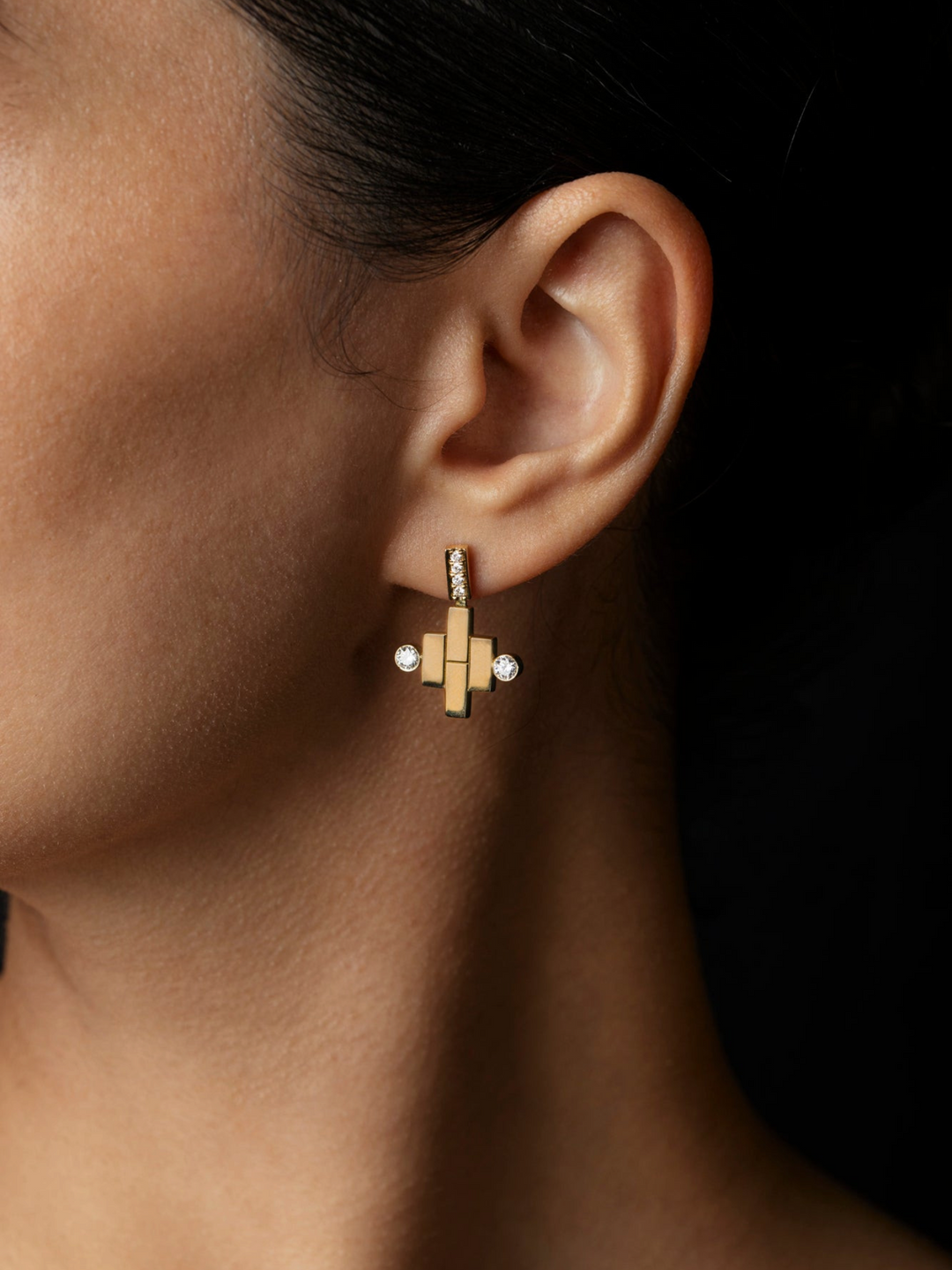 Ileana Makri dangling pond earrings in 18k yellow gold with pave white diamonds worn on a pierced earlobe