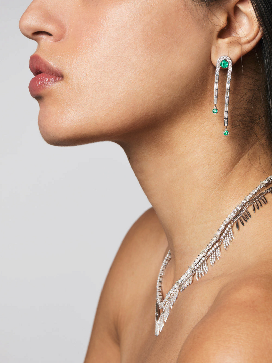 Ileana Makri Frozen Stream earrings in 18k white gold with emeralds and baguette diamonds worn by a model