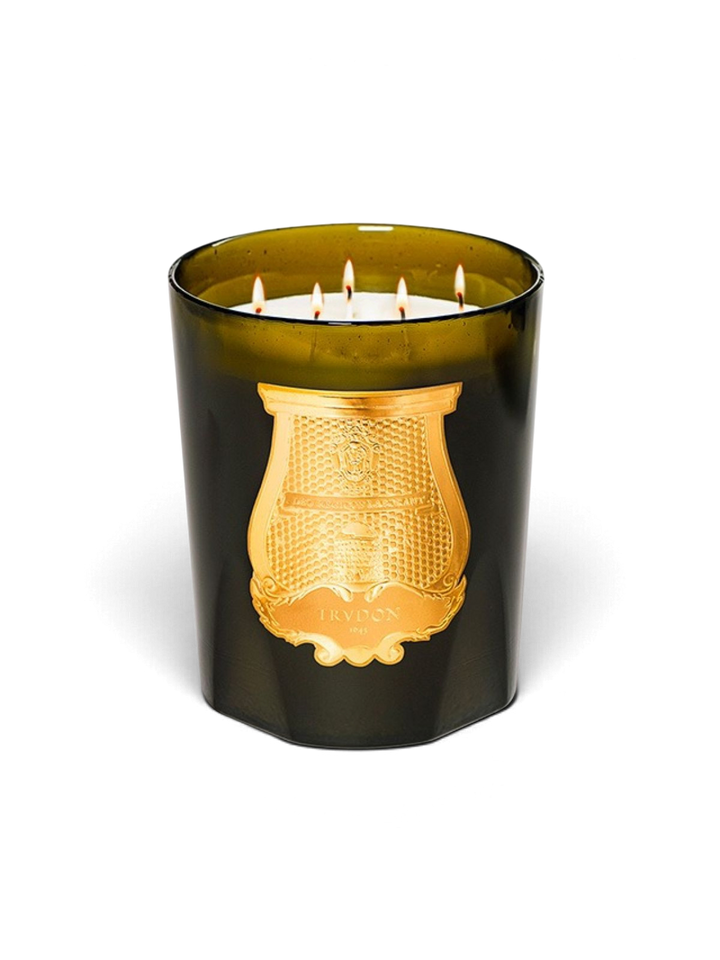 Ileana Makri Trudon Ernesto Grande candle in dark green glass with a gold emblem and five burning wicks.