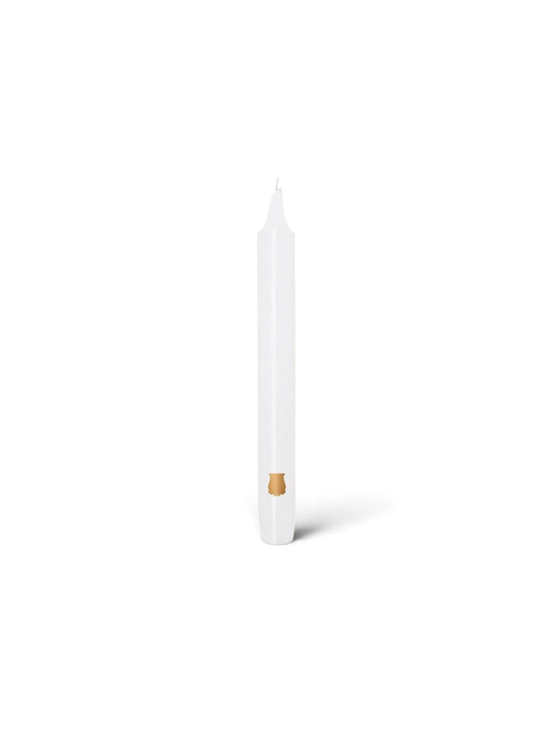 Ileana Makri white tapered Madeleine candle with a small gold emblem detail on a plain white background