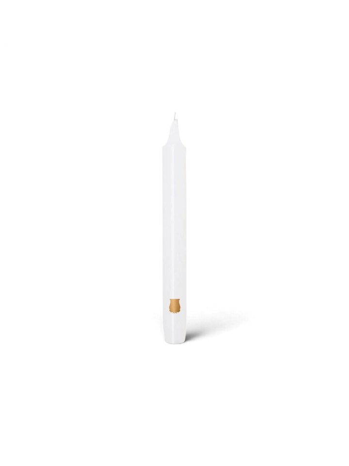 Ileana Makri white tapered Madeleine candle with a small gold emblem detail on a plain white background