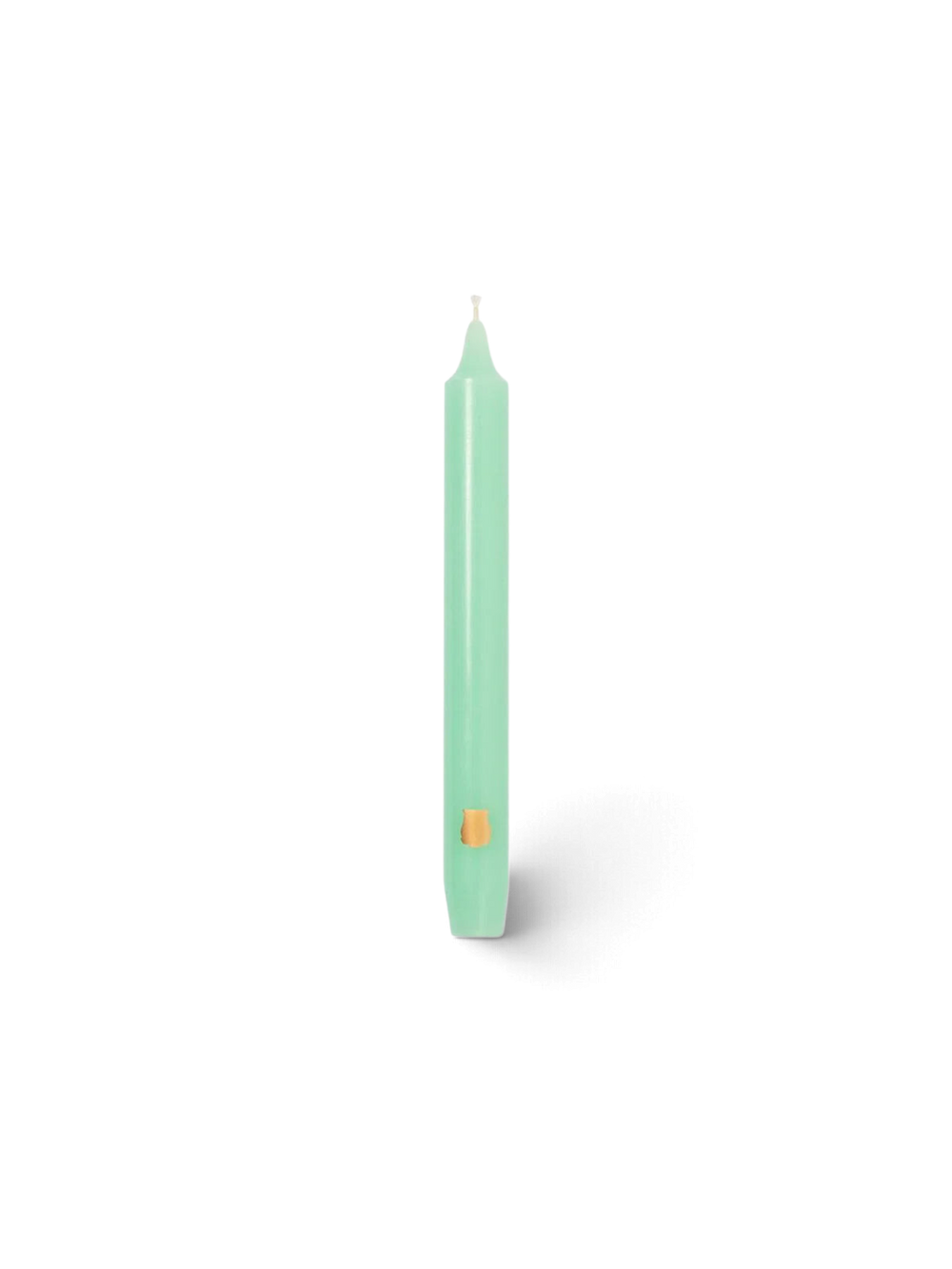 Ileana Makri watery green Madeleine tapered candle with a small gold emblem detail on a white background