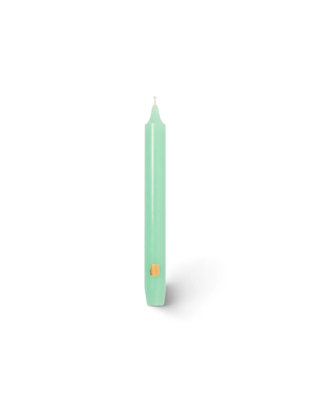 Ileana Makri watery green Madeleine tapered candle with a small gold emblem detail on a white background