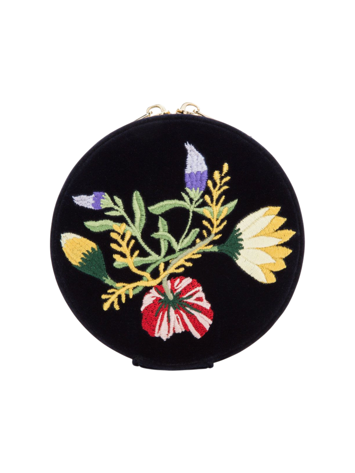 Ileana Makri round indigo velvet travel jewelry case featuring elegant floral embroidery and gold zip closure.