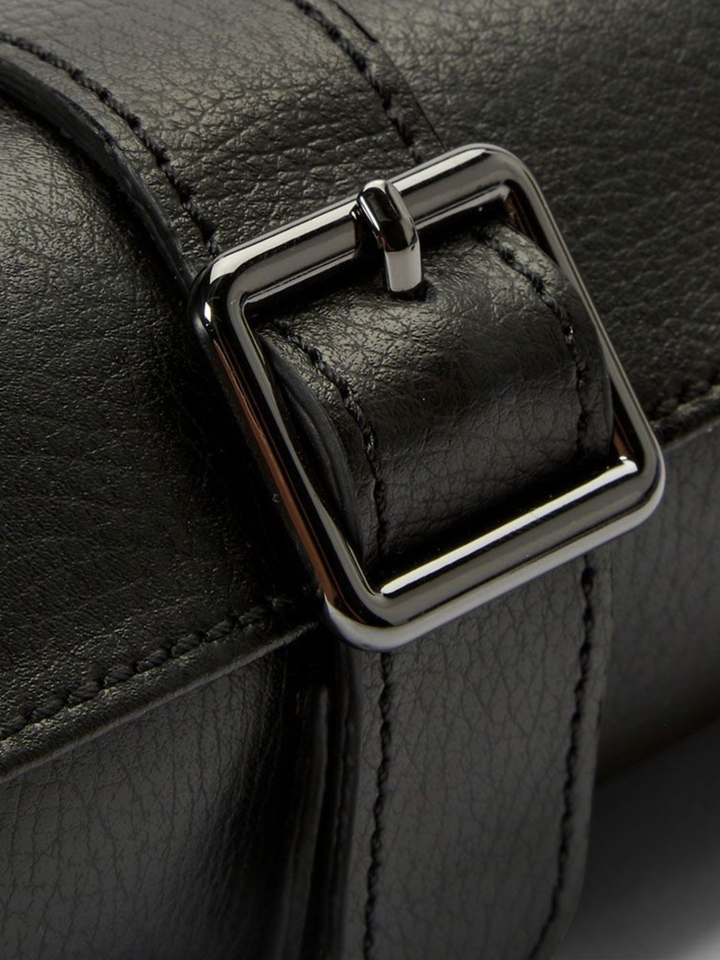 Ileana Makri black pebble grain leather triple watch roll featuring a secure adjustable buckle closure