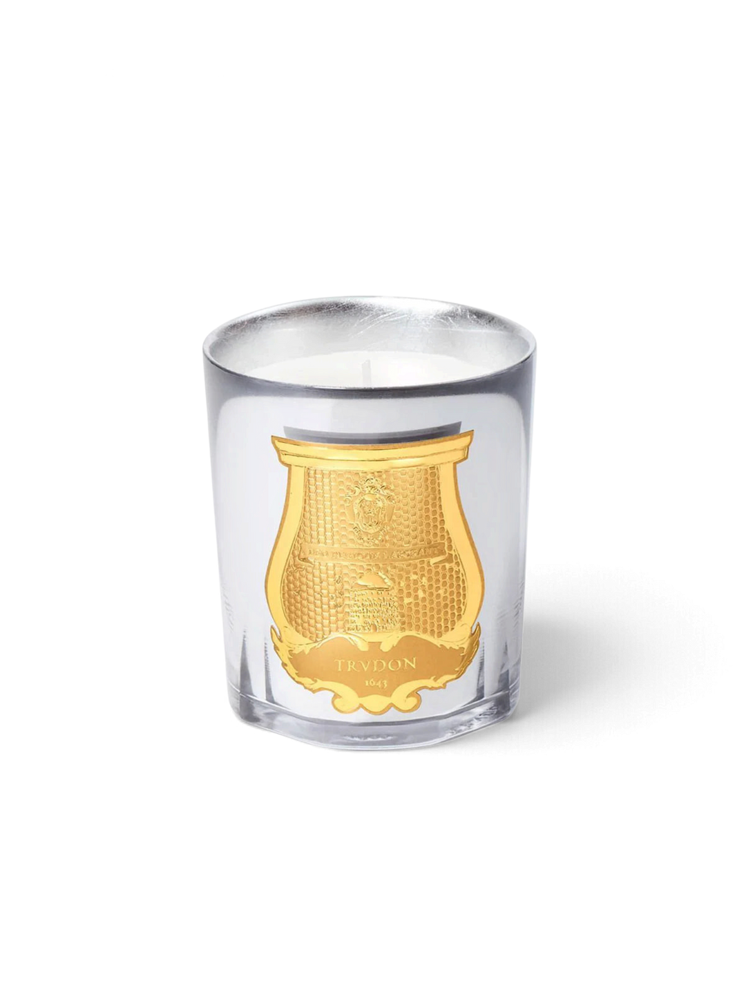 Ileana Makri Trudon Cabinet des Miroirs candle in a clear glass vessel with a gold embossed emblem.