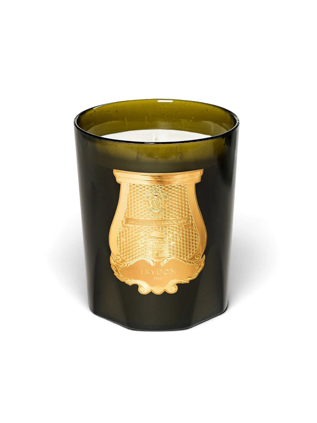 Ileana Makri Trudon Ernesto candle in a dark green glass vessel with a gold emblem, featuring leather and tobacco scent