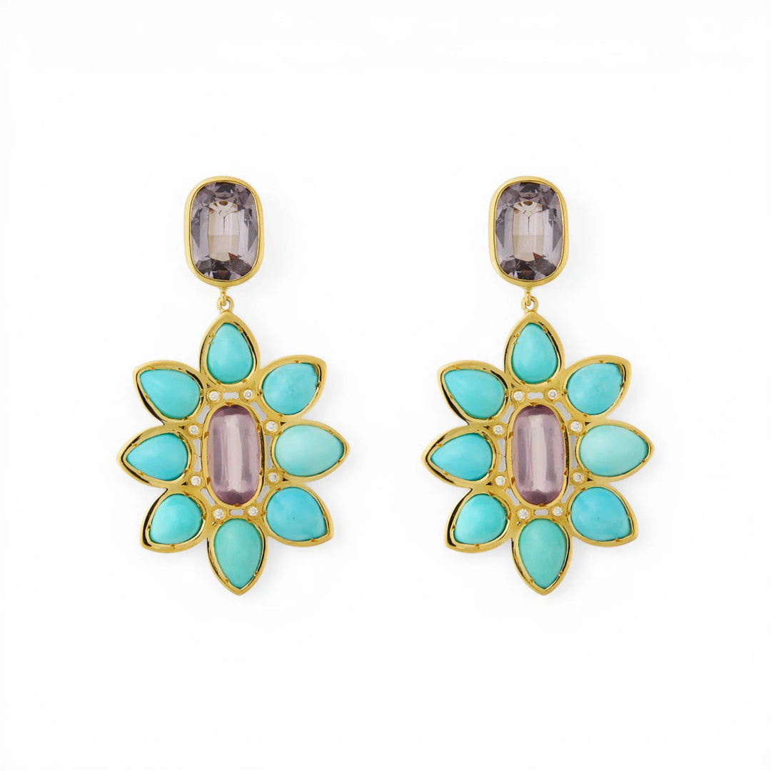 Pair of gold drop earrings with turquoise and purple spinel in a floral design on white background