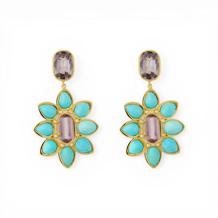 Pair of gold drop earrings with turquoise and purple spinel in a floral design on white background